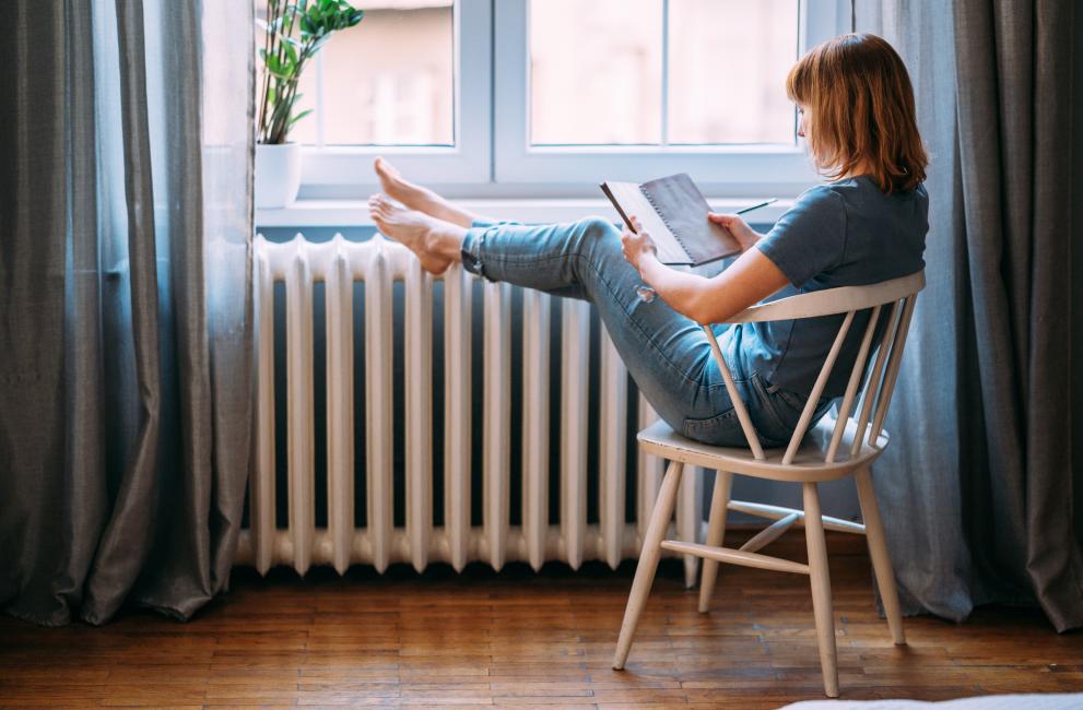 woman sitting next to radiator